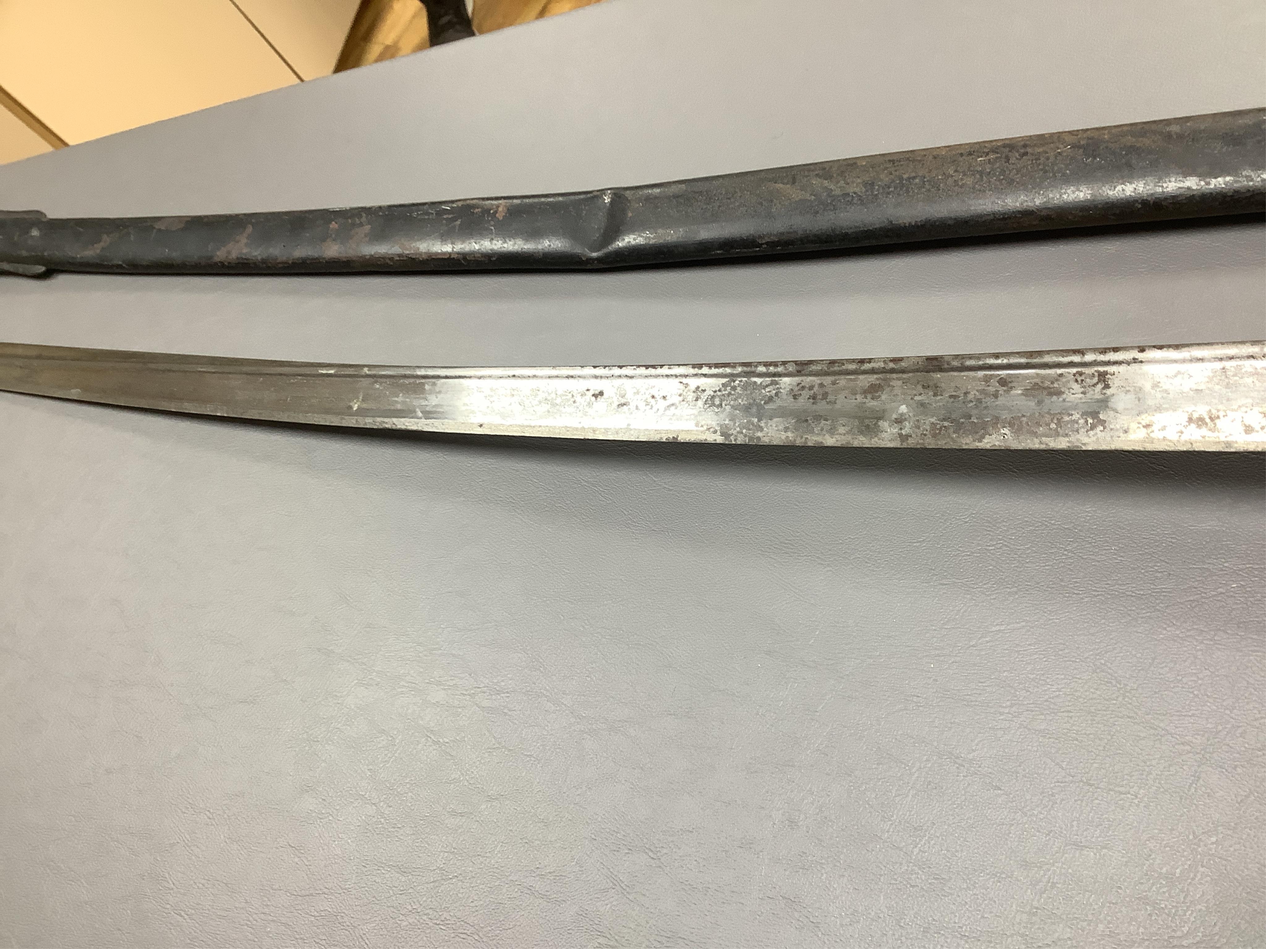 A First World War Turkish army officer’s sword, with pipe back blade, regulation iron guard pierced with crescent and moon, chequered horn grips, in its iron scabbard, together with an unidentified bayonet in its scabbar